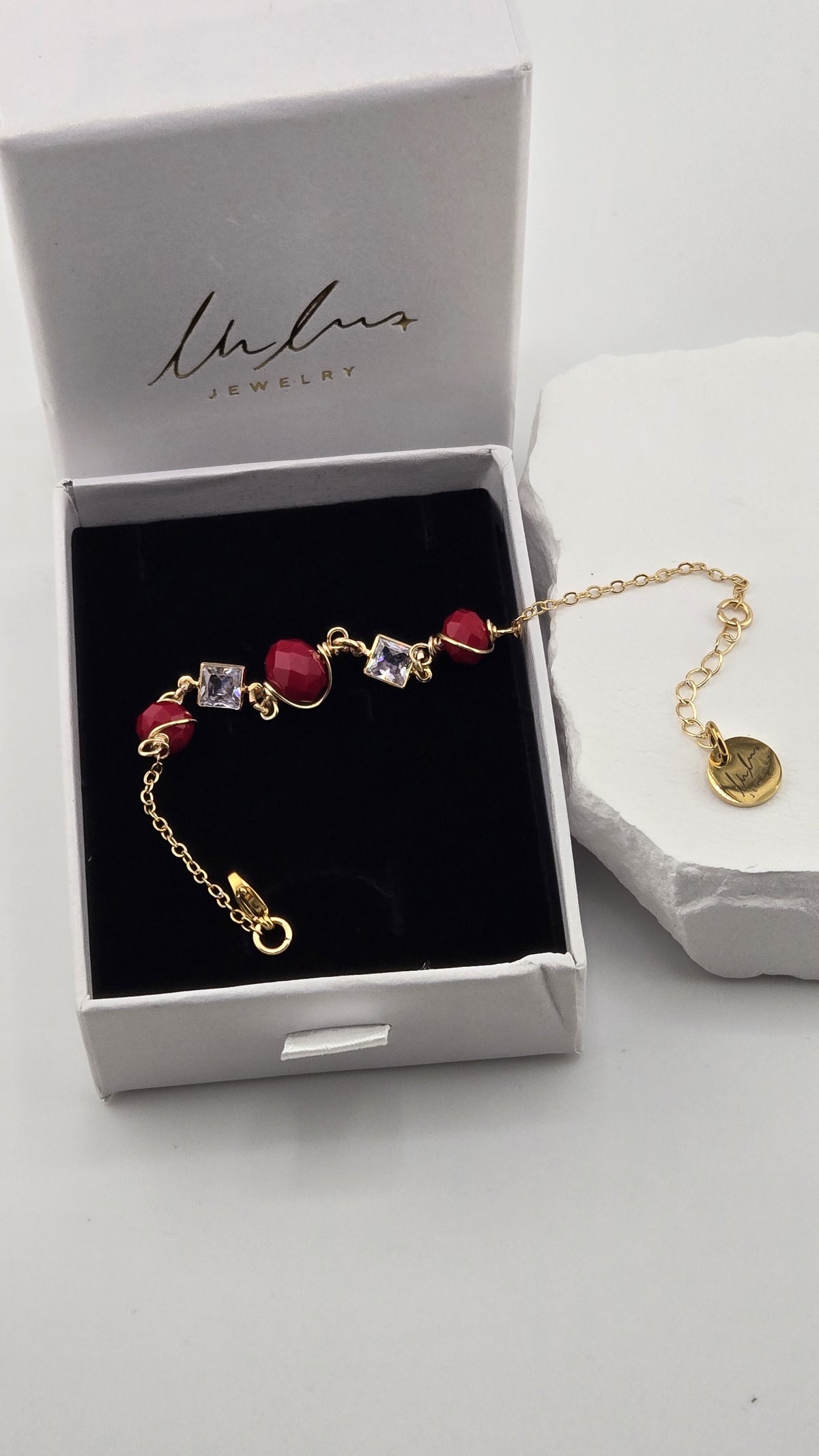 Poppy Facet Bracelet in a LuluTouch gift box, showing the lobster clasp, extender chain and round LuluTouch tag