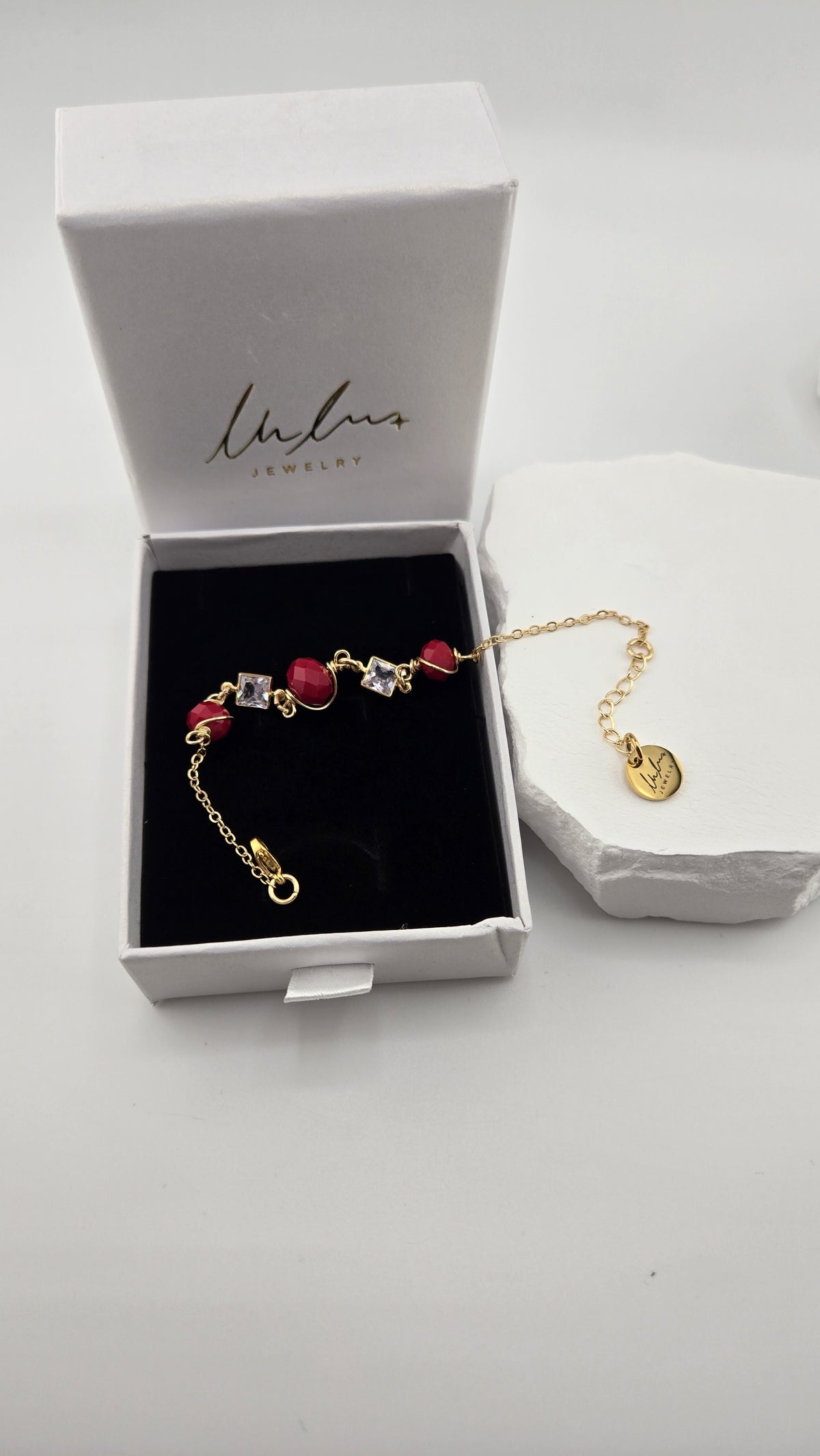Poppy Facet Bracelet laid in an open LuluTouch box on black velvet