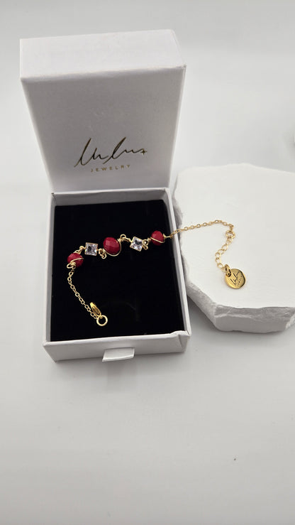 Poppy Facet Bracelet laid in an open LuluTouch box on black velvet