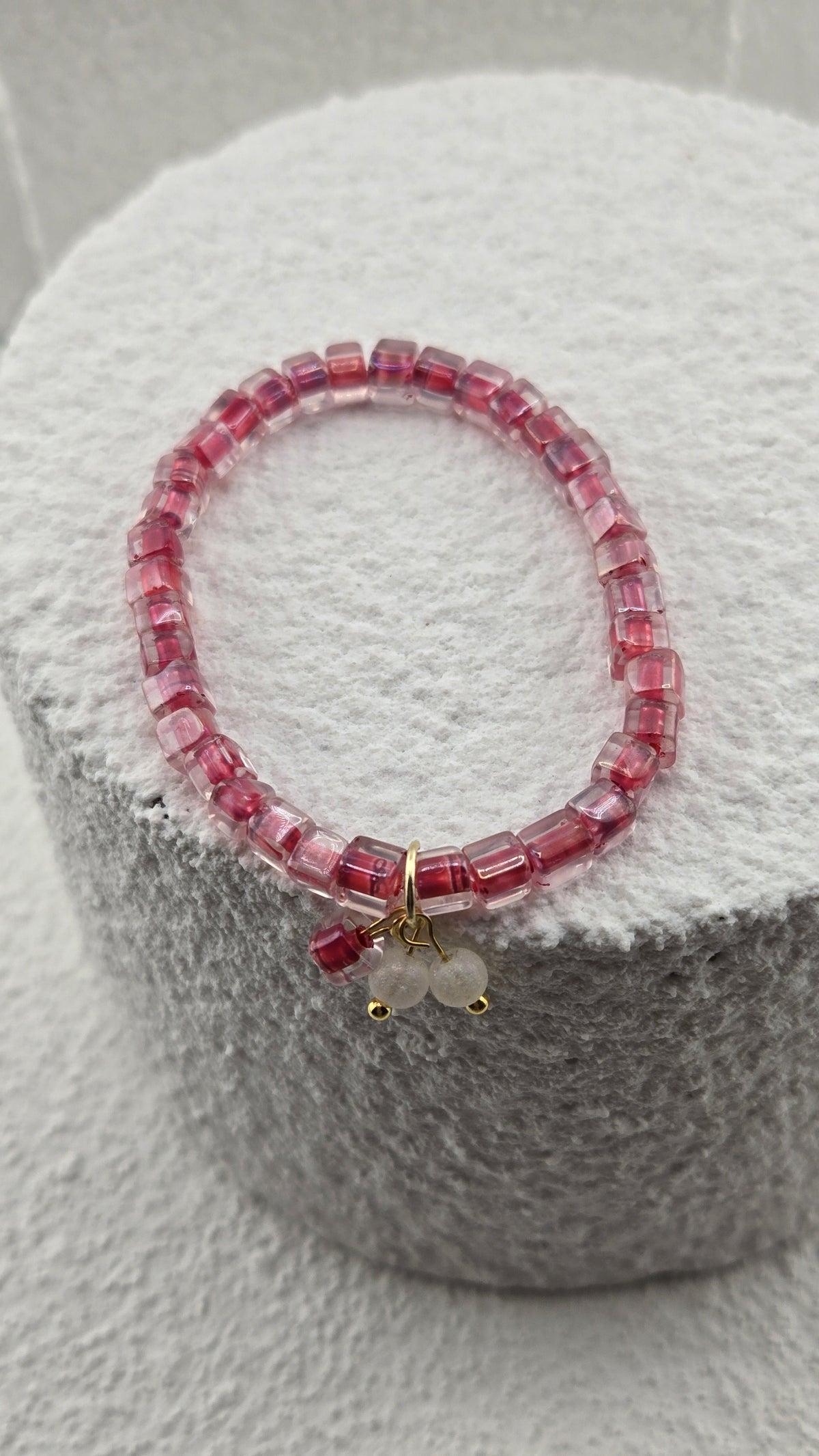 Side view of the Rosewater Bead Bracelet pink cube beads