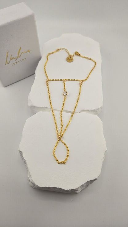 Solitaire Hand Chain laid flat on white stone