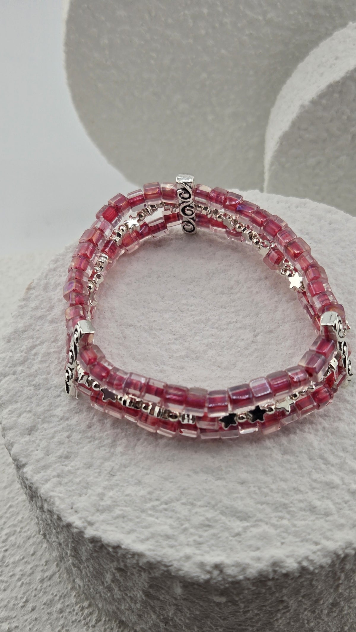Starlit Raspberry Bracelet, three rows of raspberry-pink cube beads with silver-tone swirl bars and star beads