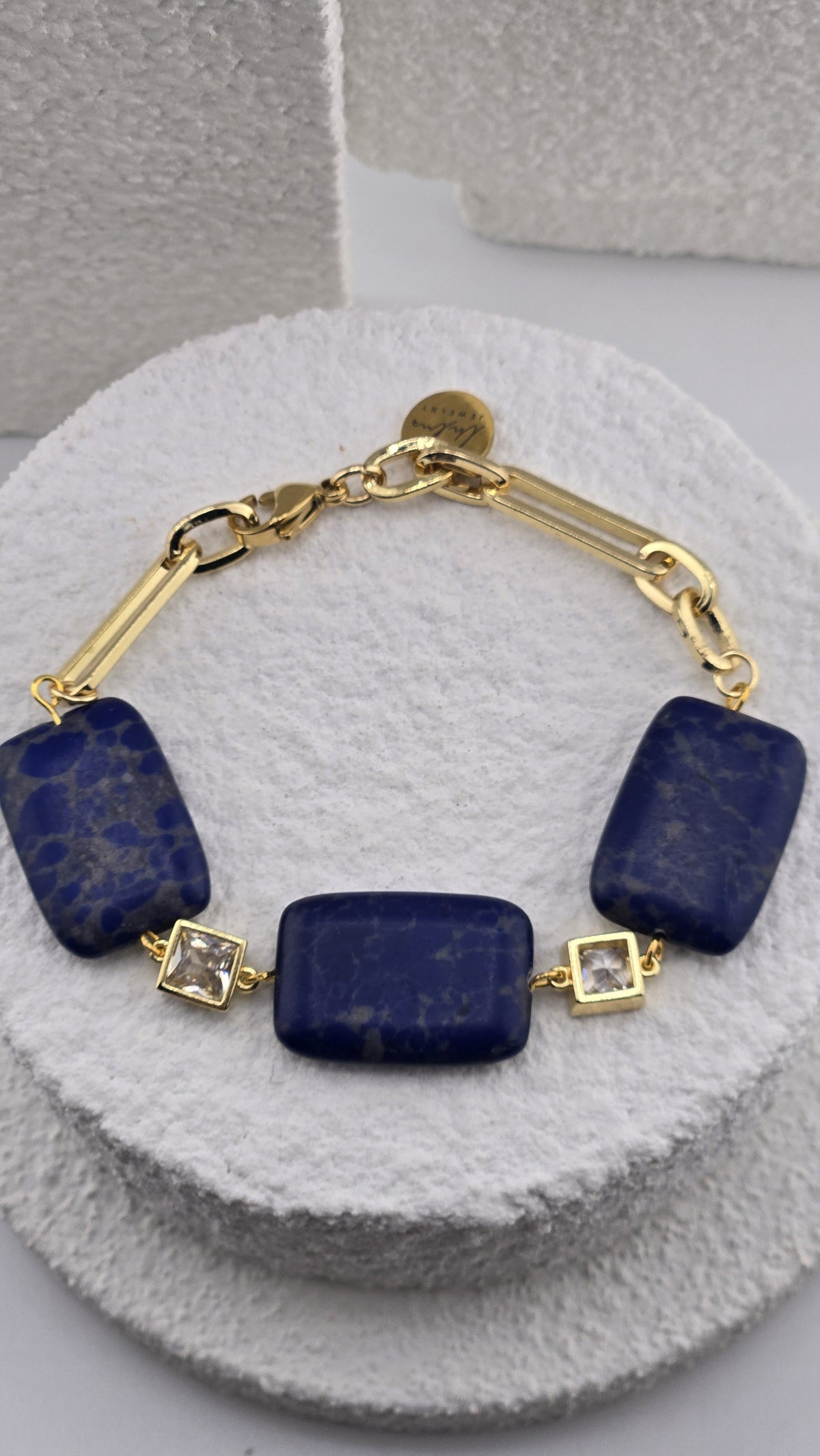 Ultramarine Link Bracelet showing the clear square stones in gold-plated frames