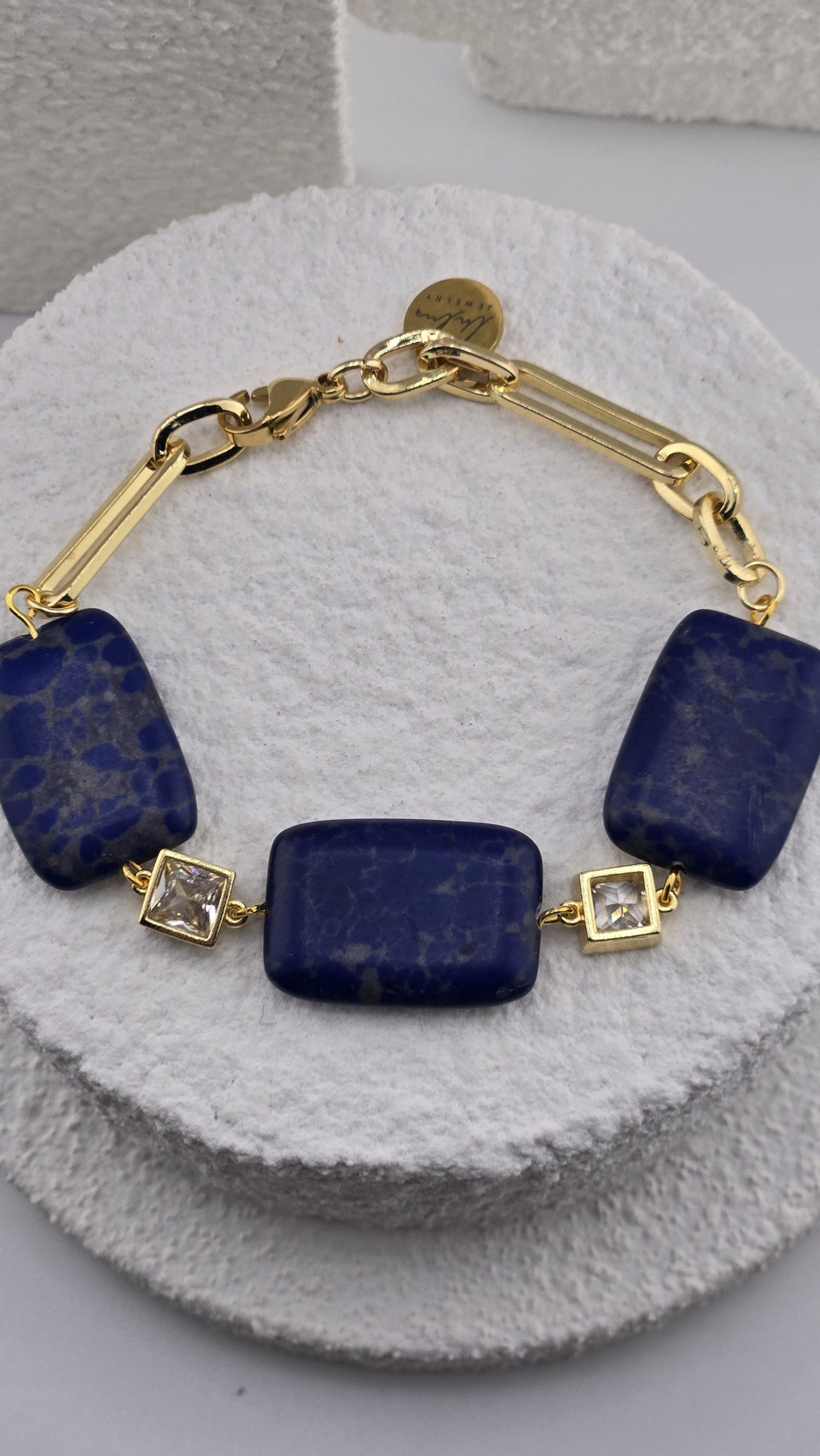 Close view of the Ultramarine Link Bracelet blue beads and gold chain