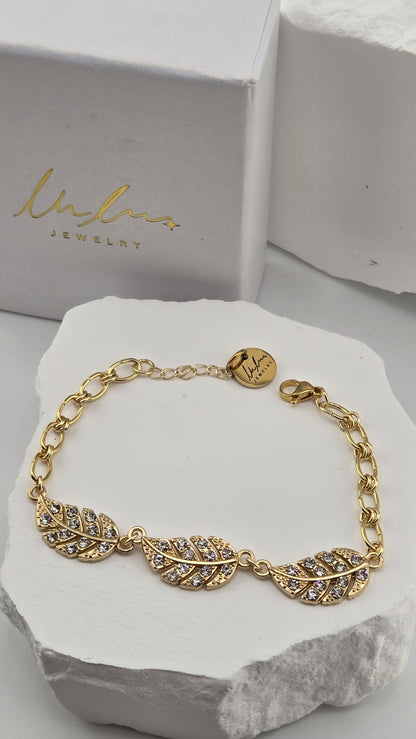 Wingtip Bracelet in front of a LuluTouch gift box, showing the lobster clasp, extender chain and round LuluTouch tag